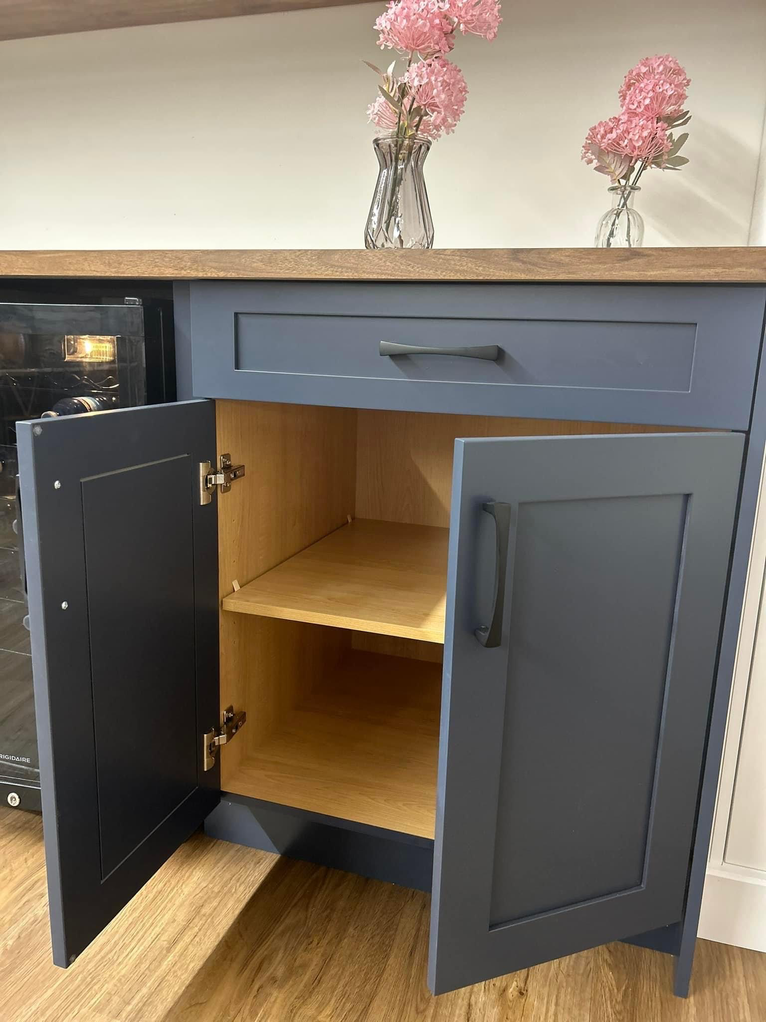 Custom lower cabinetry in a deep blue