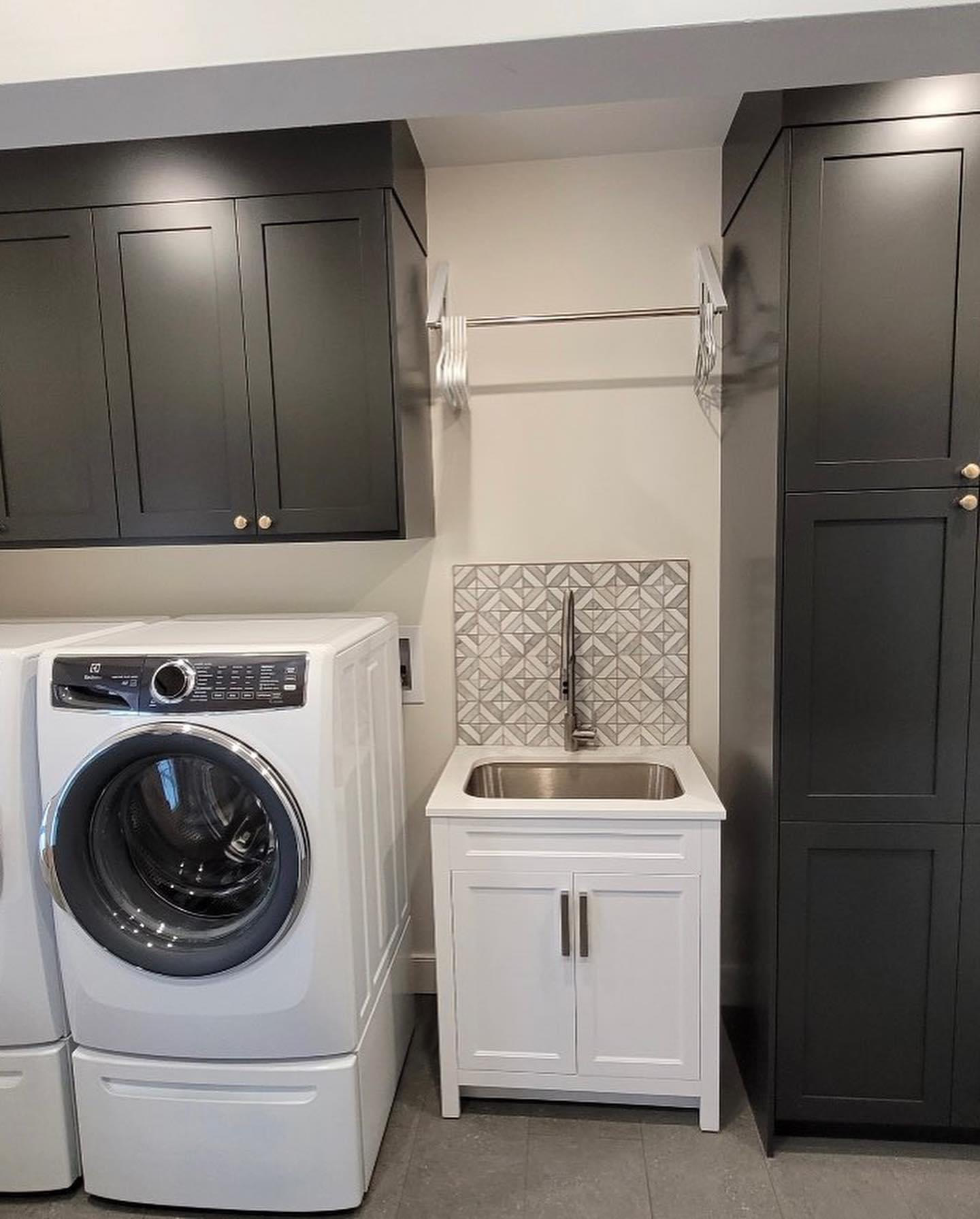 Narrow view of remodelled laundry room with custom cabinetry