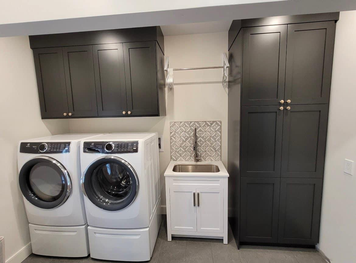 Wide view of an overhauled laundry room, complete with custom cabinetry