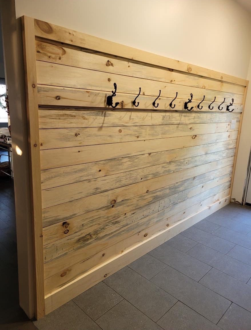 Shiplap wall lined with coat hooks