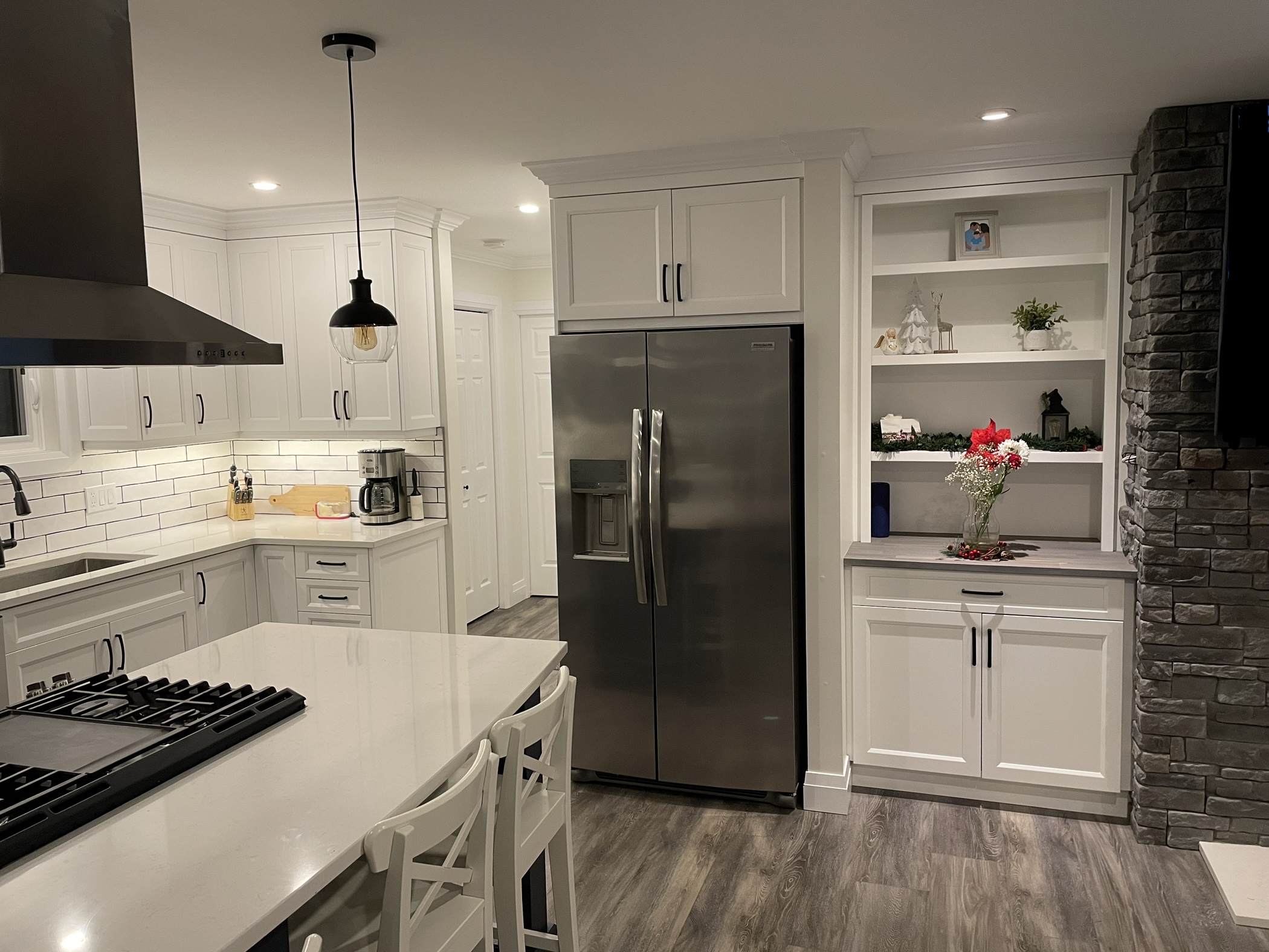 View of fridge and hutch after full kitchen renovation with custom cabinetry by SSP Cabinetry