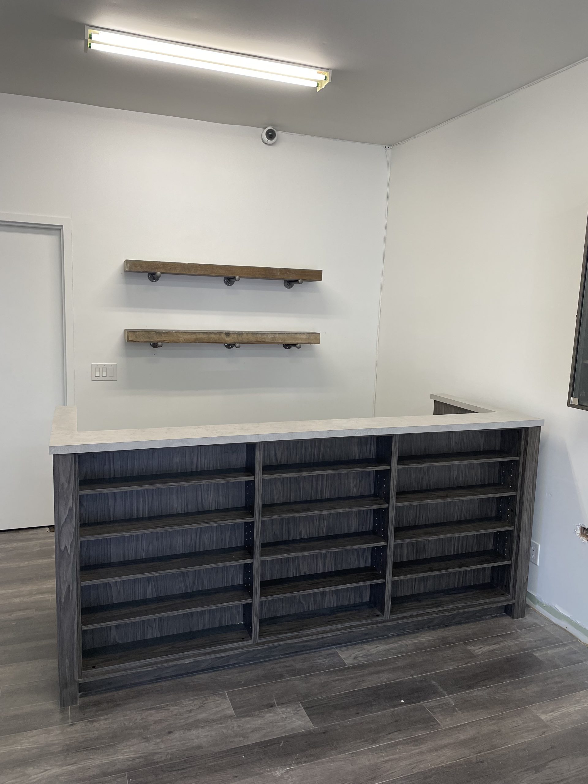 View of custom storefront cabinetry for Village Bud