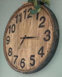 Whiskey barrel clock hanging on wall